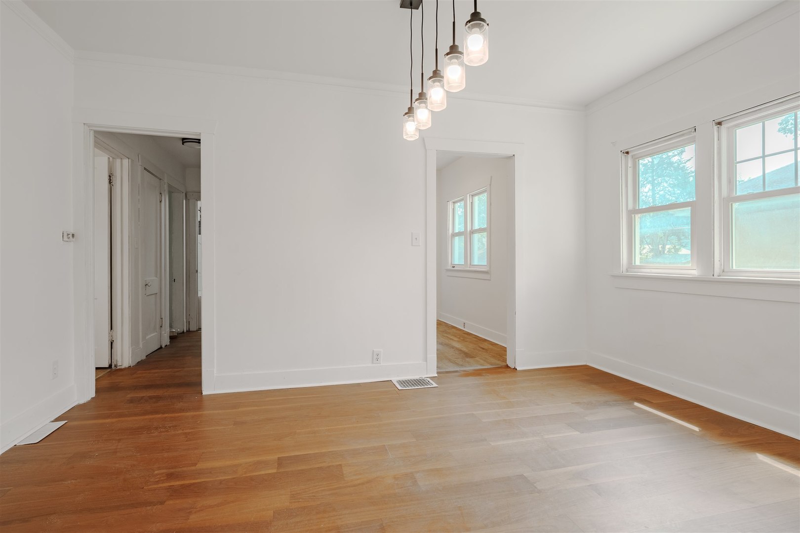 804 North Walnut Street Pontiac, IL 61764 - Photo 7 of 38 an empty room with wooden floor and windows