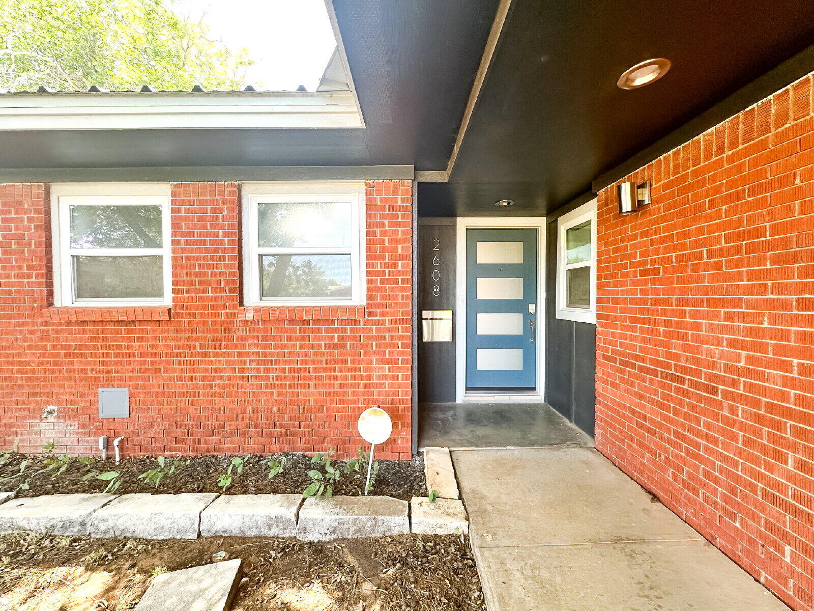 2608 Raleigh Avenue Lubbock, TX 79410 - Photo 2 of 23 a view of a brick house with a bench