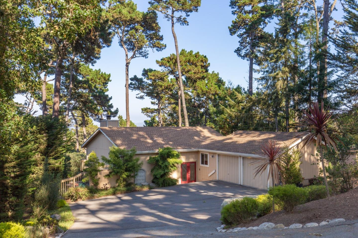 a view of house with a yard and a trees