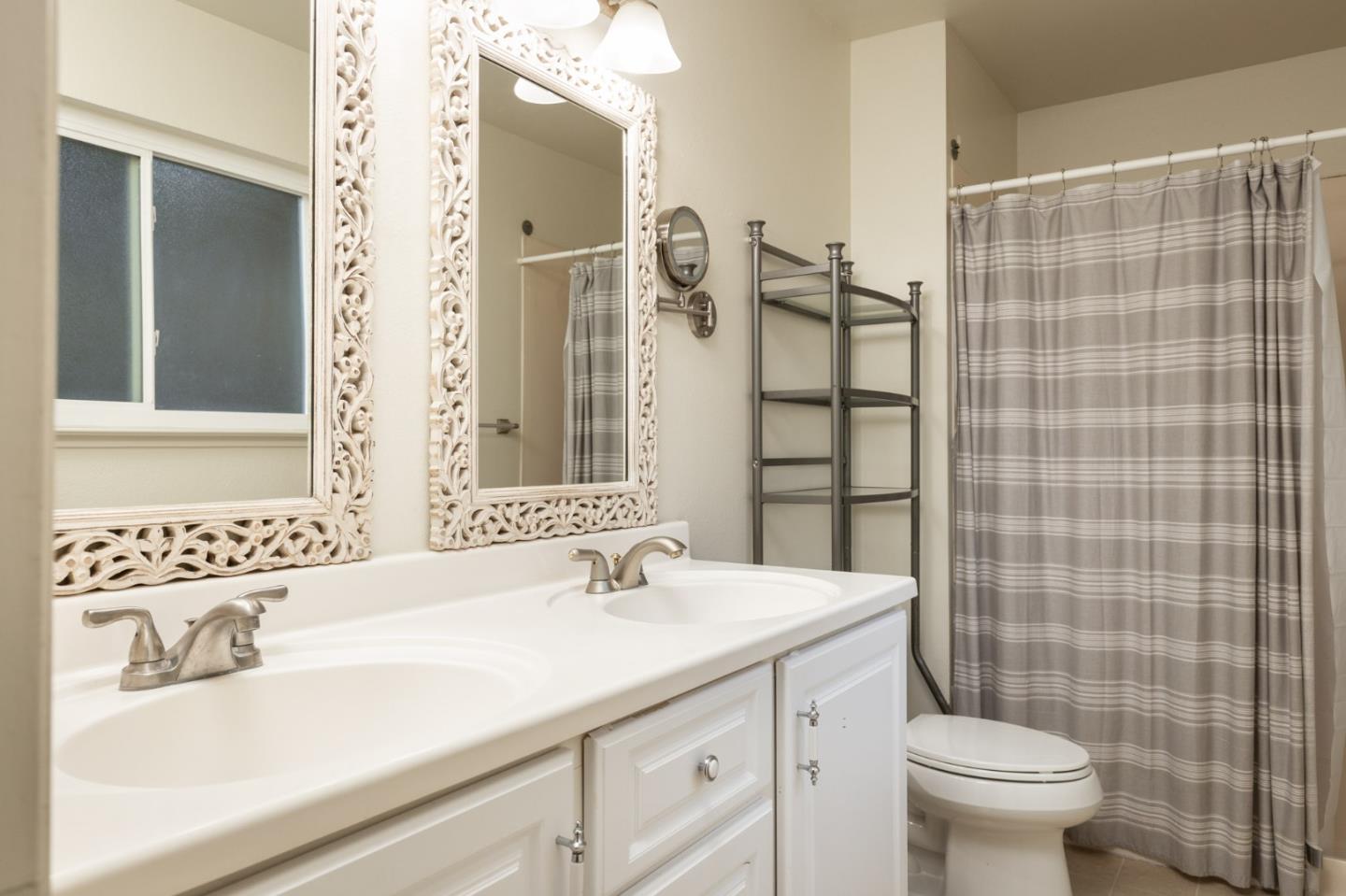 4095 Crest Road Pebble Beach, CA 93953 - Photo 12 of 21 a bathroom with a sink a toilet and shower curtain