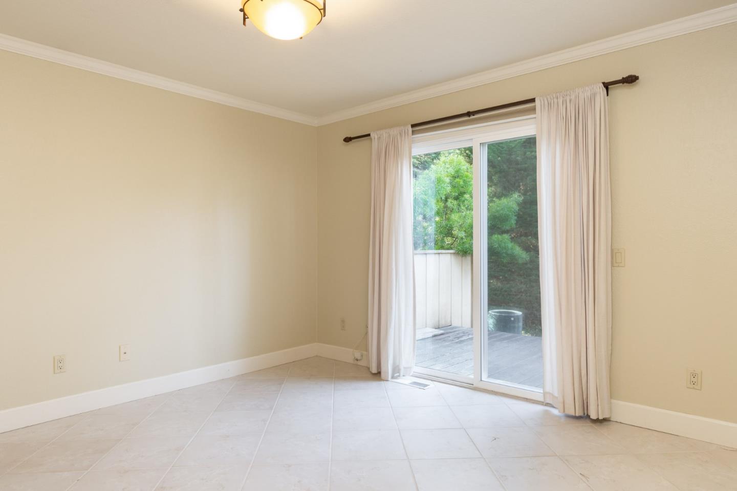 4095 Crest Road Pebble Beach, CA 93953 - Photo 13 of 21 an empty room with wooden floor and windows