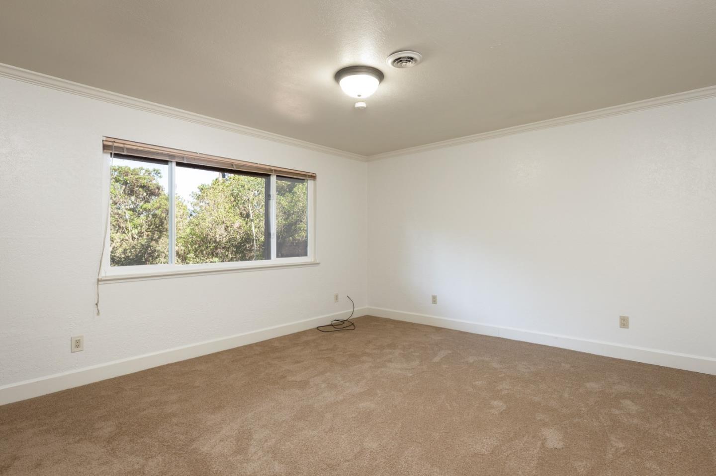 4095 Crest Road Pebble Beach, CA 93953 - Photo 15 of 21 an empty room with a window