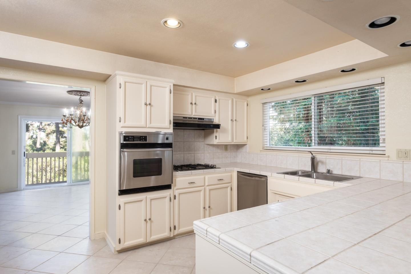 4095 Crest Road Pebble Beach, CA 93953 - Photo 4 of 21 a kitchen with granite countertop white cabinets and white appliances