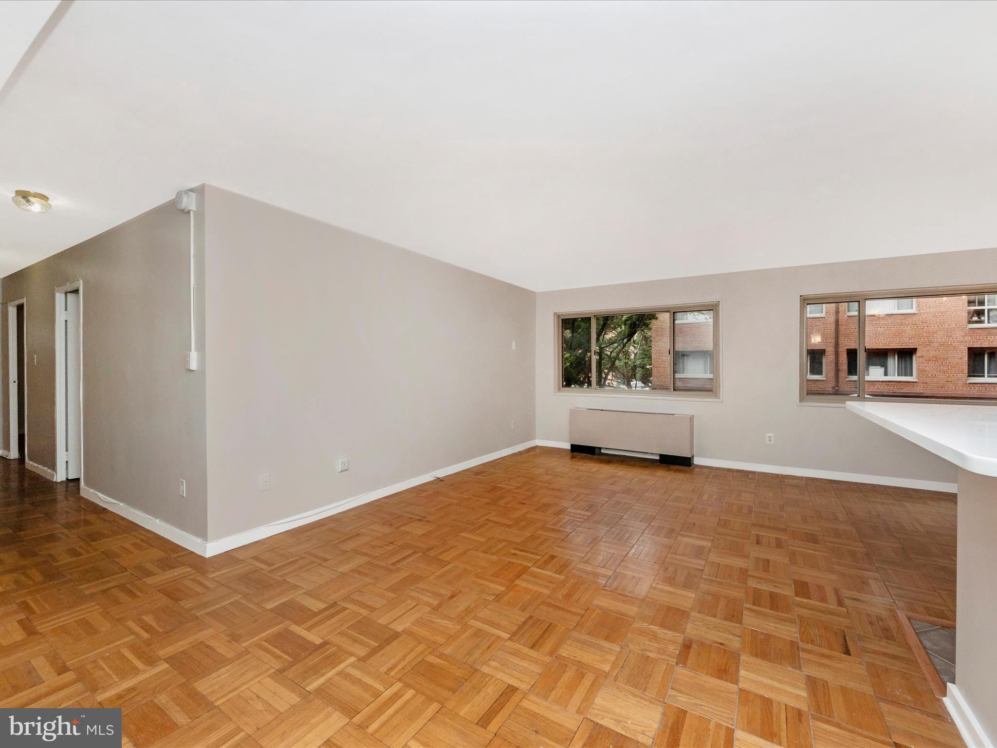 3900 Tunlaw Road Northwest, Unit 104 Washington, DC 20007 - Photo 7 of 36 Unstaged living room.