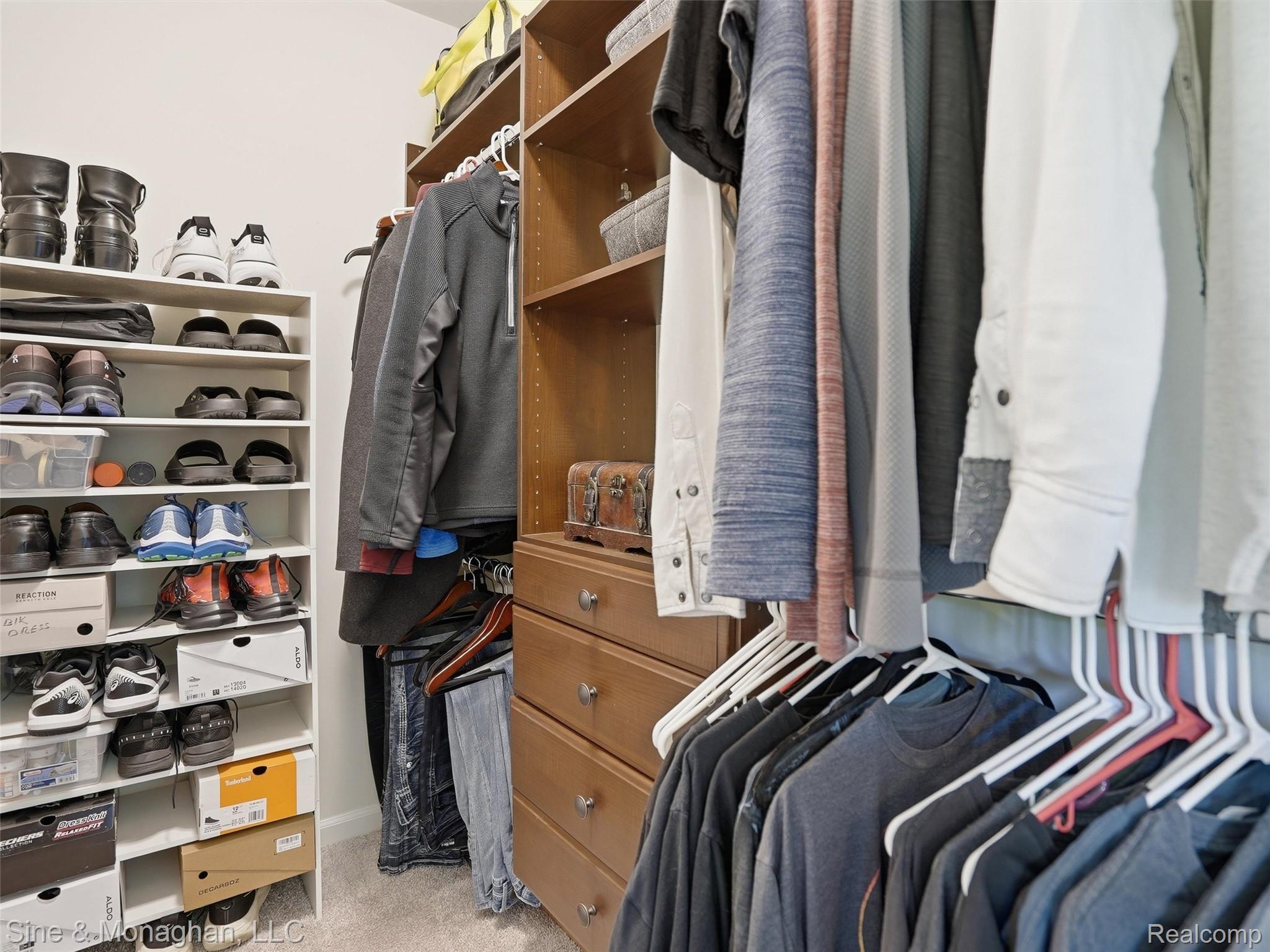 24827 Ivy Road Novi, MI 48375 - Photo 17 of 38 Custom closet system featuring built-in shelving, hanging rods, and drawers