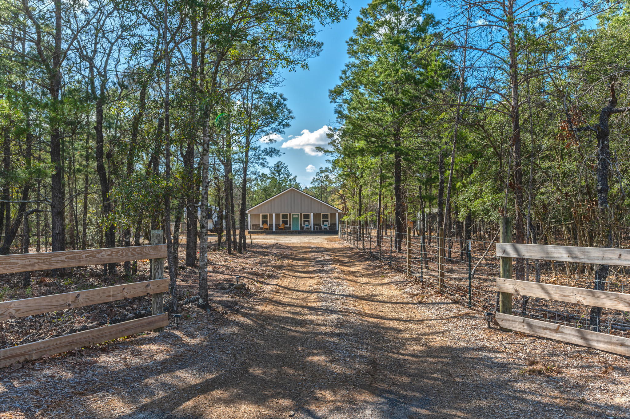 149 Delaware Road DeFuniak Springs, FL 32433 - Photo 1 of 36 a view of a road with trees in the background