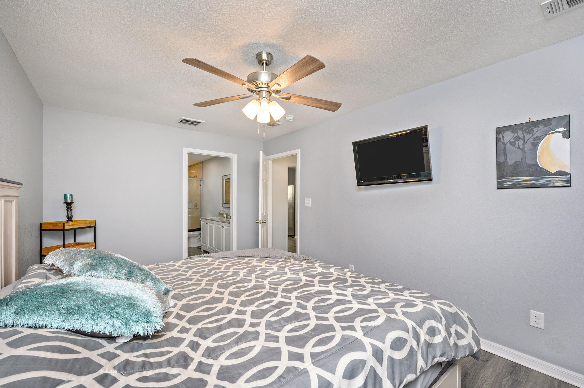 149 Delaware Road DeFuniak Springs, FL 32433 - Photo 16 of 36 a bedroom with a large bed and a chandelier