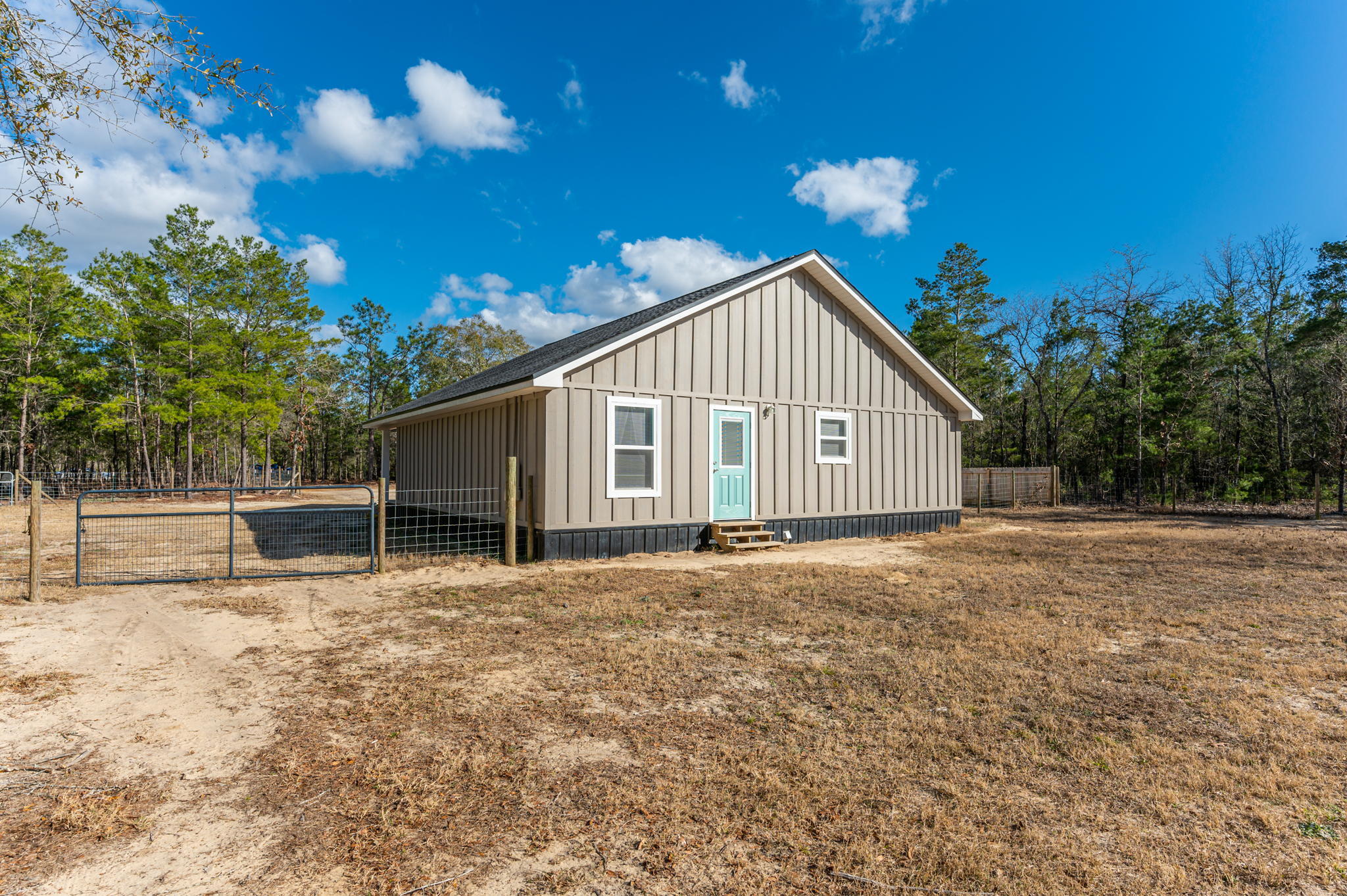 149 Delaware Road DeFuniak Springs, FL 32433 - Photo 32 of 36 a view of a house with a yard and garage