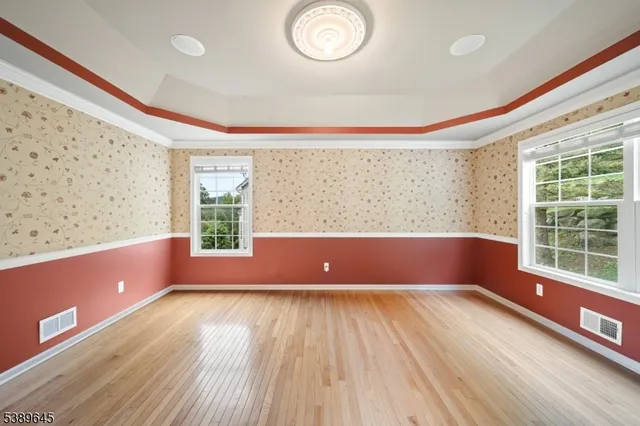 a view of room with window and wooden floor