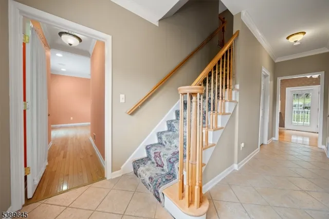 a view of an entryway with wooden floor and stairs