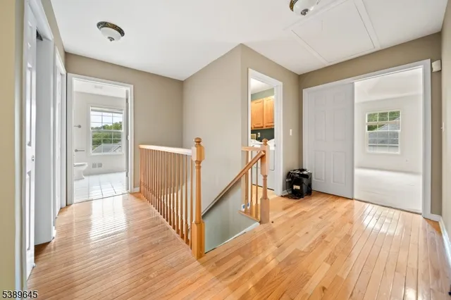 a view of a livingroom with wooden floor and stairs