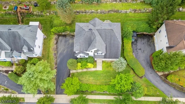 an aerial view of a house with a yard and outdoor seating