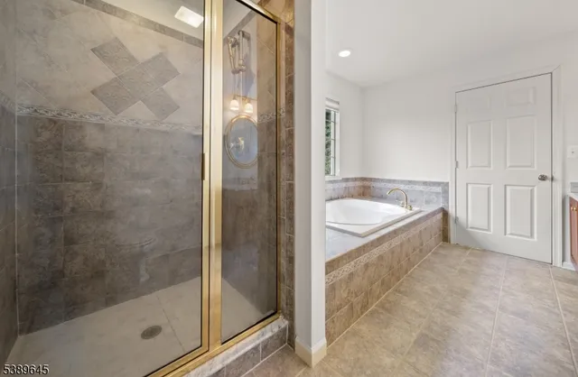 a bathroom with a bathtub and shower