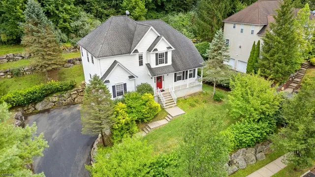 a view of a house with a yard and potted plants