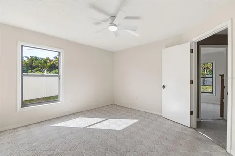 an empty room with windows and closet