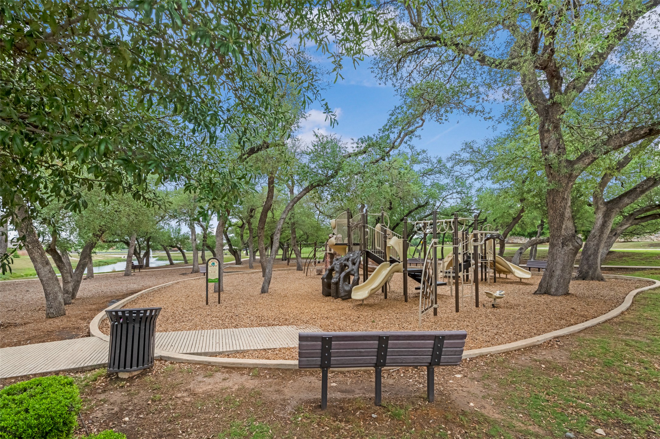 1101 Arbor Acres Loop Leander, TX 78641 - Photo 19 of 19 a park view with a bench and trees