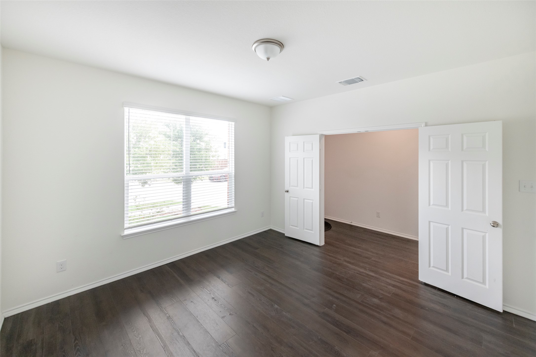1101 Arbor Acres Loop Leander, TX 78641 - Photo 2 of 19 an empty room with wooden floor and windows