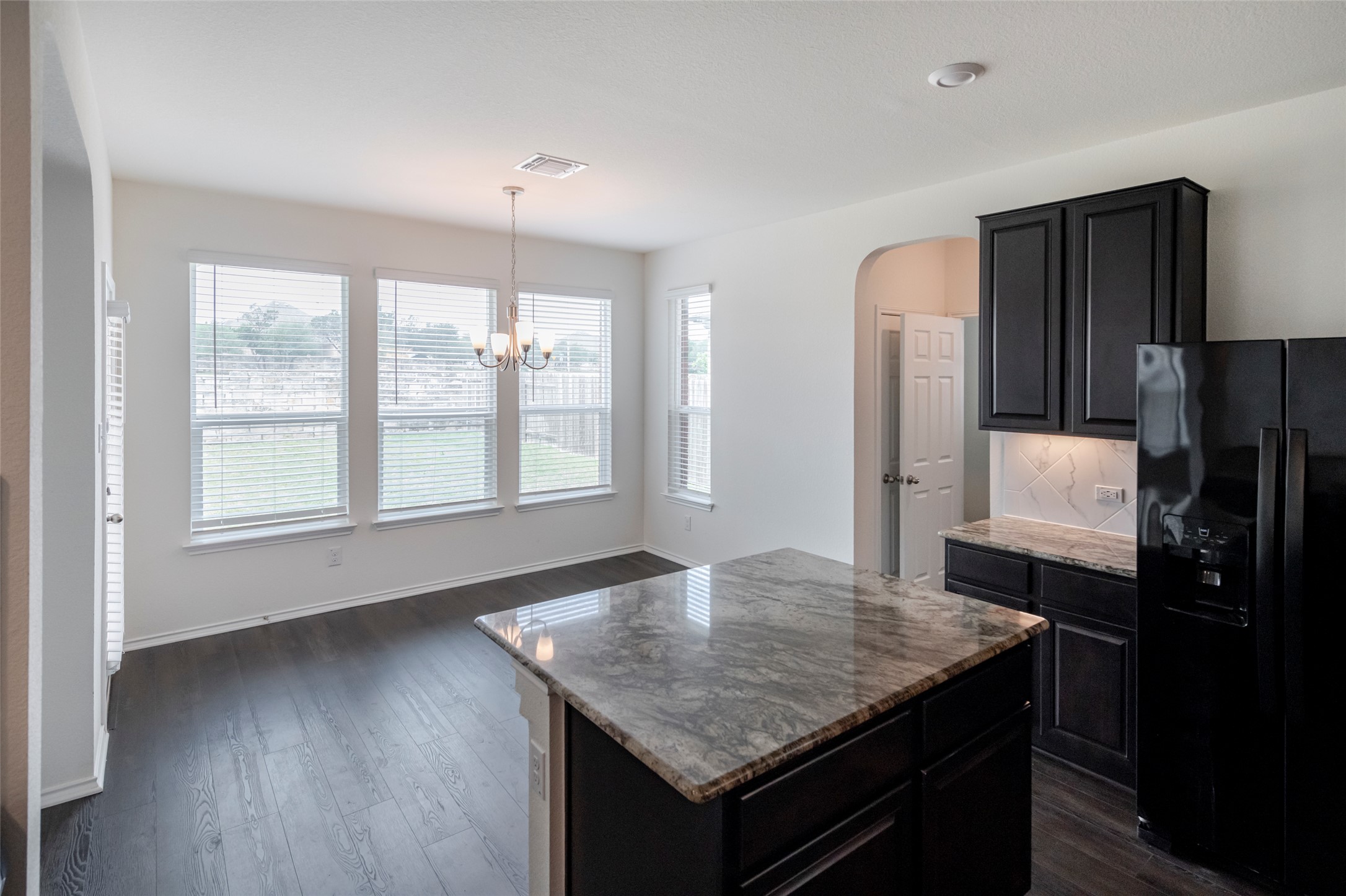 1101 Arbor Acres Loop Leander, TX 78641 - Photo 5 of 19 a kitchen with a table chairs refrigerator and window