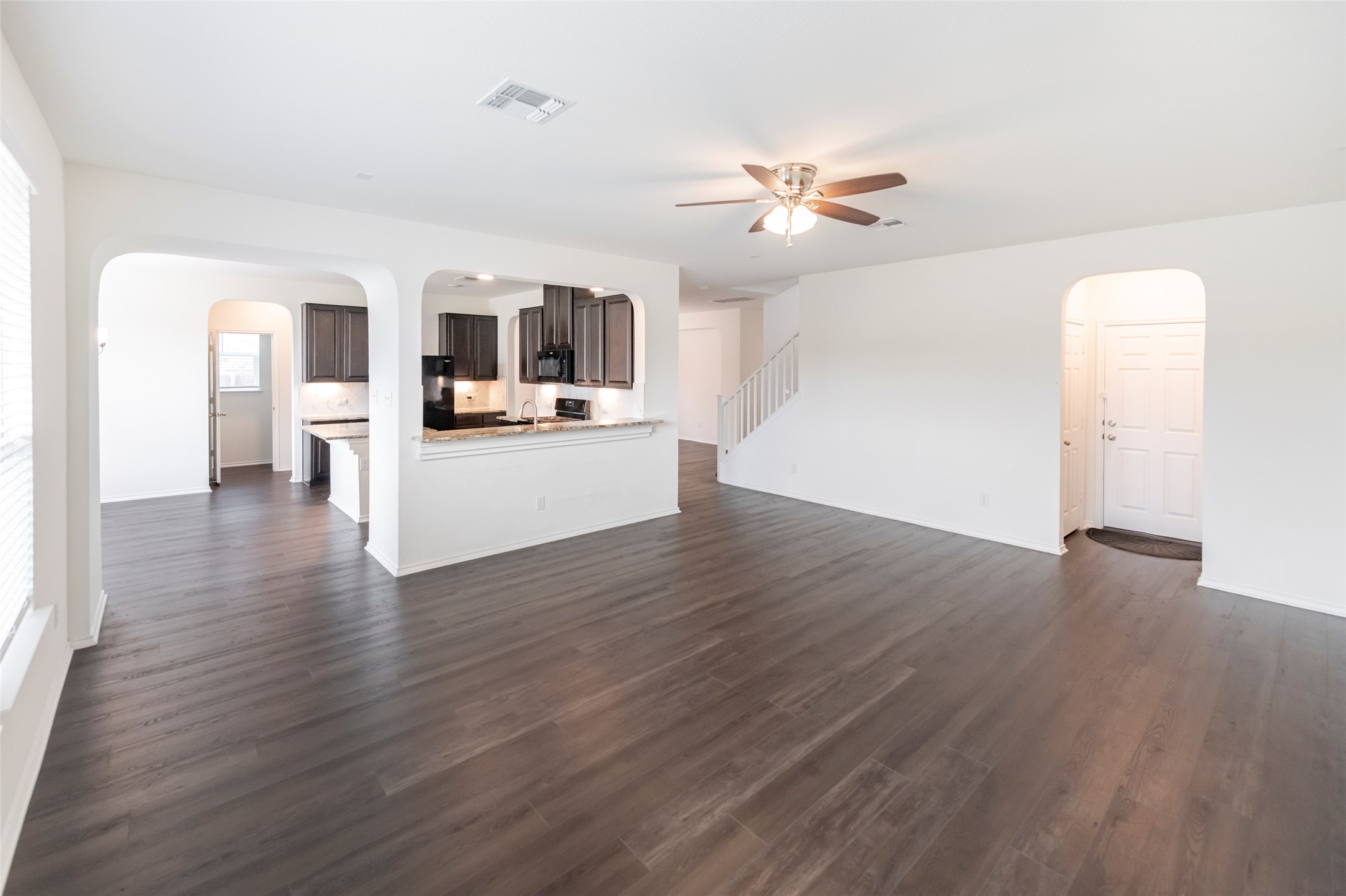 1101 Arbor Acres Loop Leander, TX 78641 - Photo 6 of 19 a view of a livingroom with wooden floor and a ceiling fan