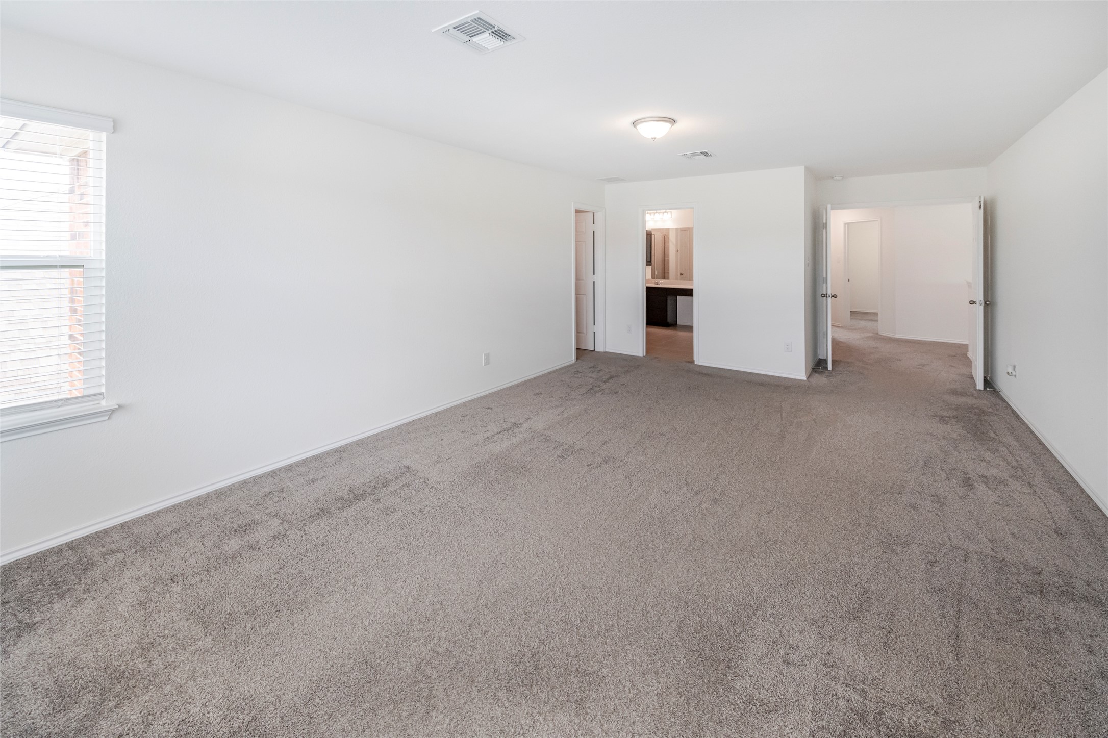 1101 Arbor Acres Loop Leander, TX 78641 - Photo 10 of 19 an empty room with a kitchen and a window