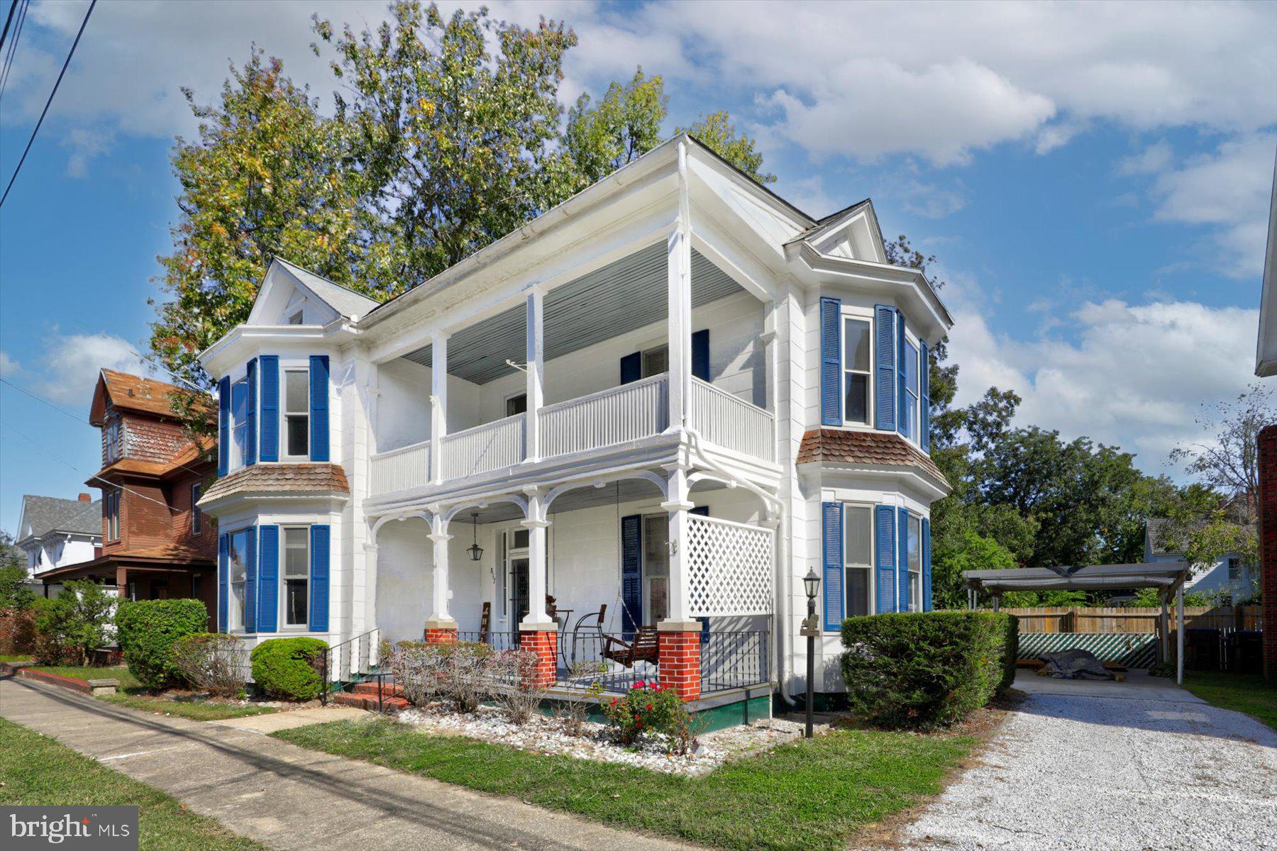 817 Locust Street Cambridge, MD 21613 - Photo 1 of 49 a front view of a house with porch and garden