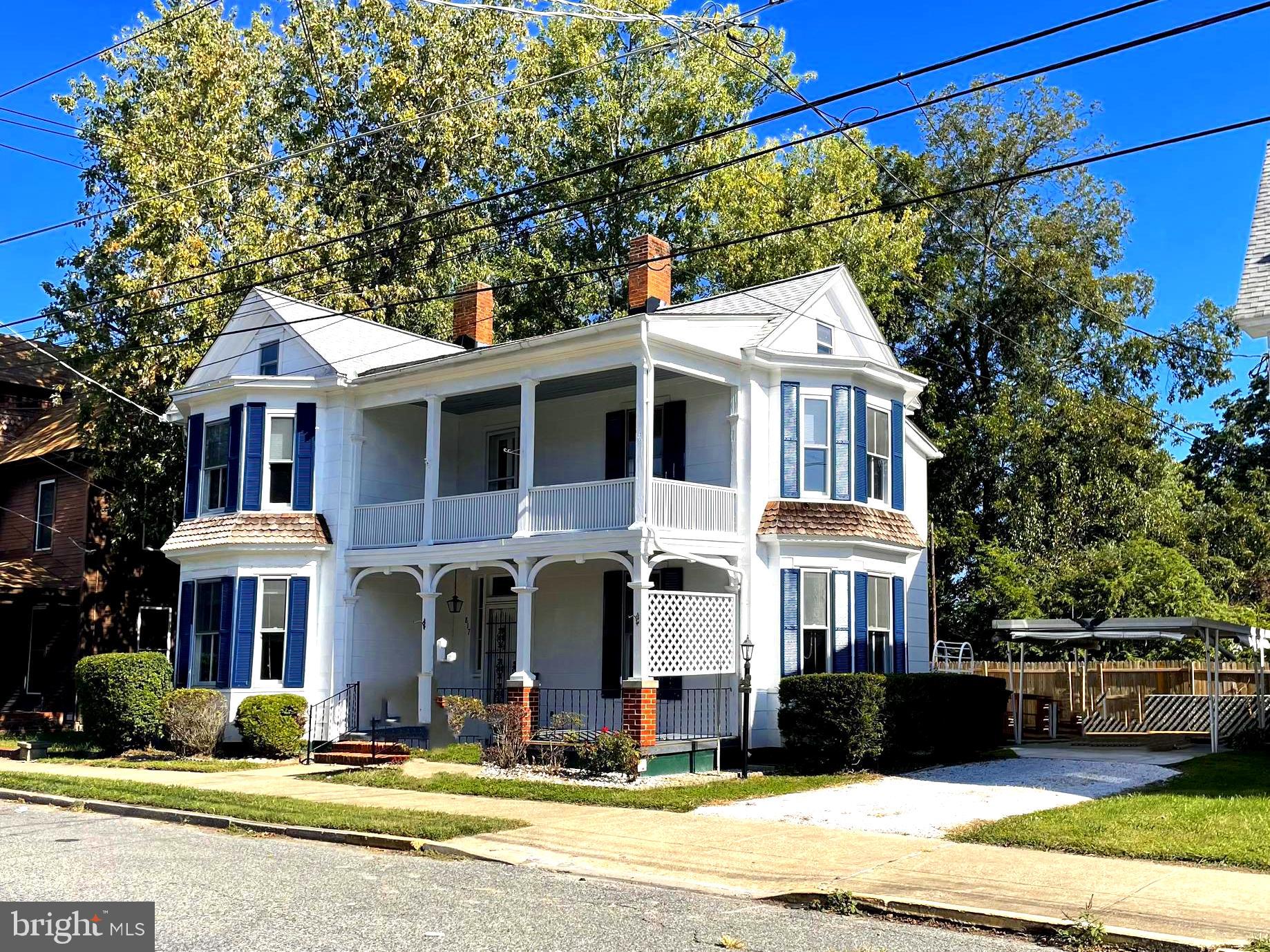 817 Locust Street Cambridge, MD 21613 - Photo 47 of 49 a front view of a residential apartment building with a yard