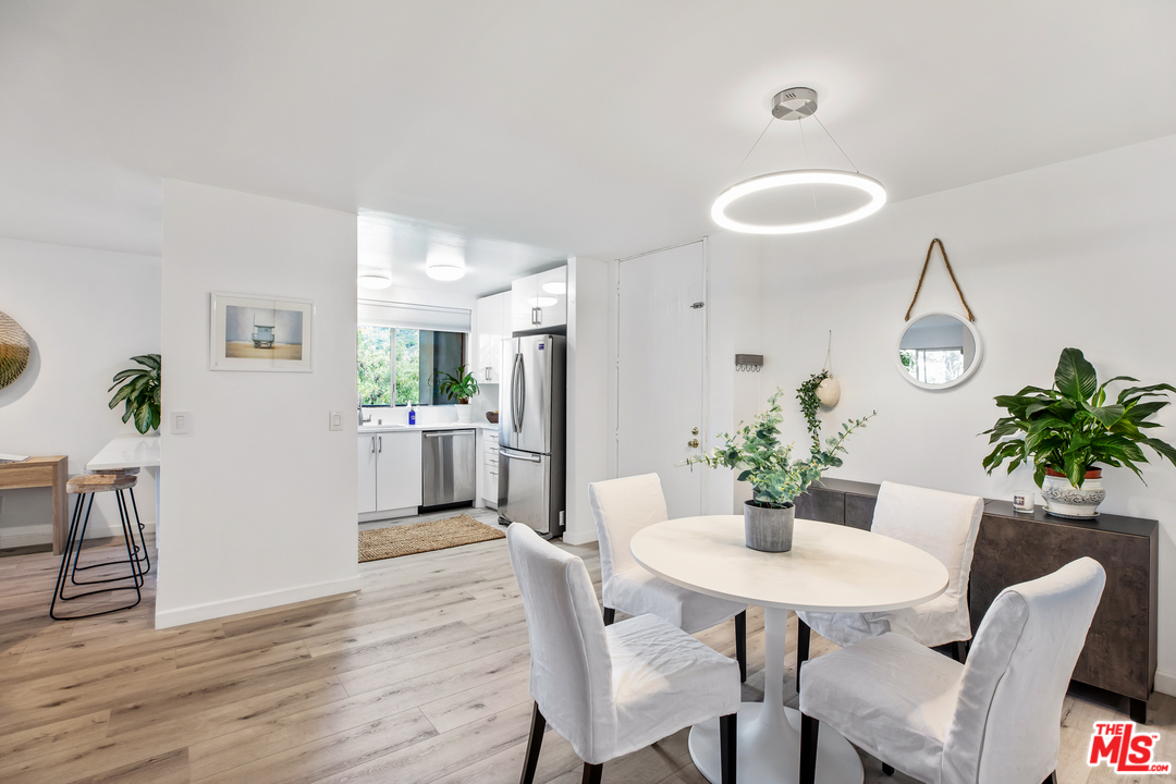 8303 Raintree Circle Culver City, CA 90230 - Photo 11 of 26 a view of a dining room with furniture and wooden floor