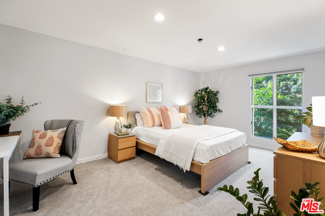 8303 Raintree Circle Culver City, CA 90230 - Photo 14 of 26 a bedroom with a bed and window