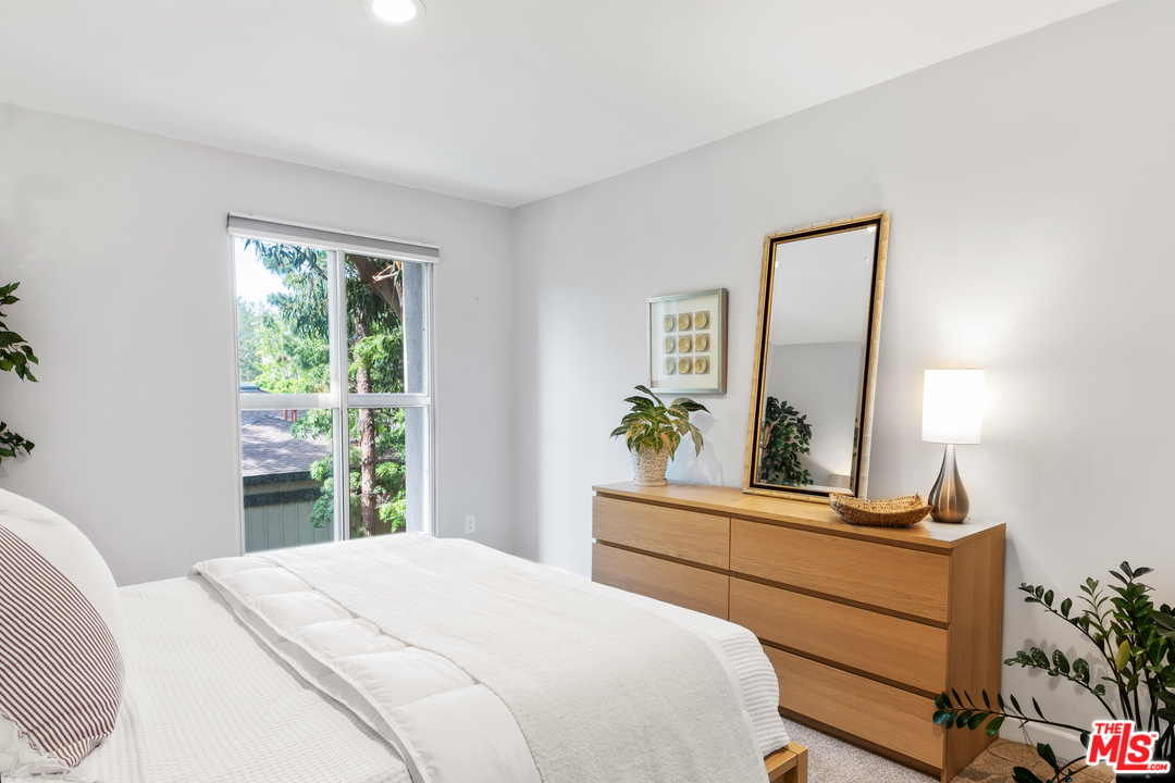 8303 Raintree Circle Culver City, CA 90230 - Photo 15 of 26 a bedroom with a bed and a dresser