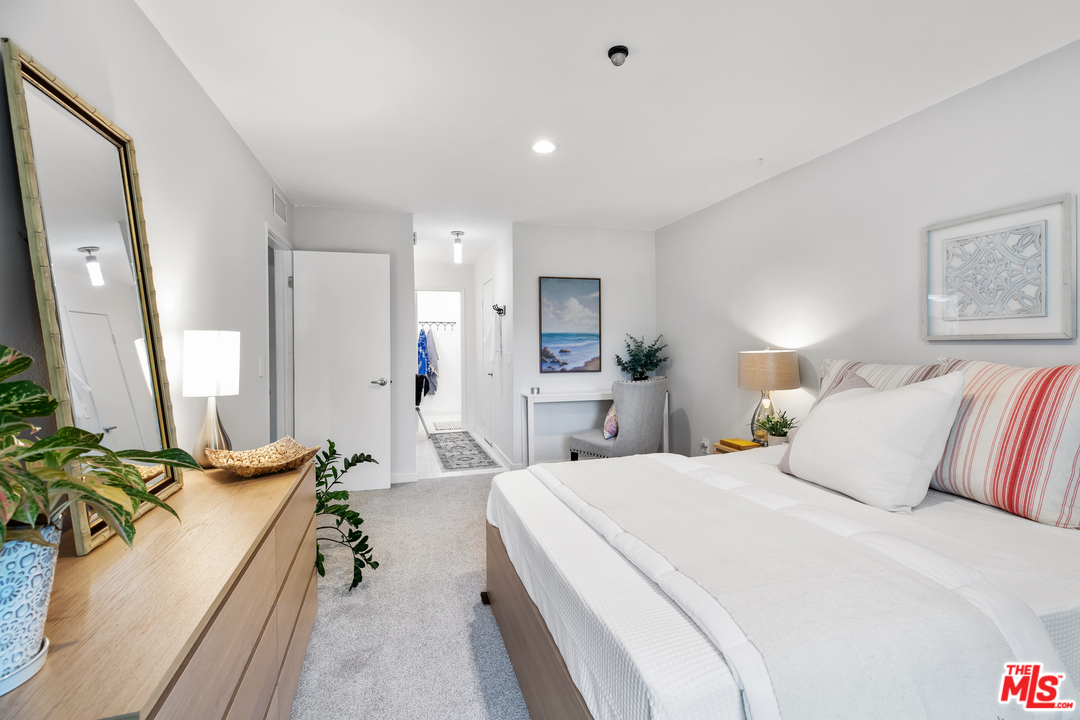 8303 Raintree Circle Culver City, CA 90230 - Photo 16 of 26 a spacious bedroom with a bed and a large mirror