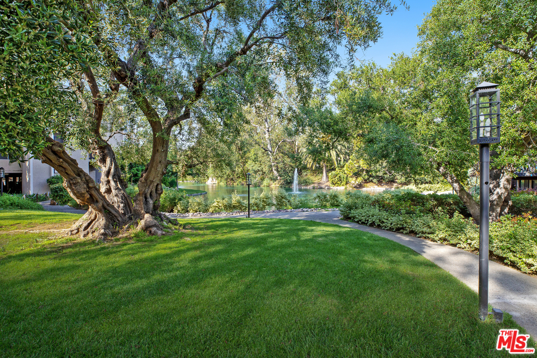 8303 Raintree Circle Culver City, CA 90230 - Photo 22 of 26 a view of a backyard with large trees