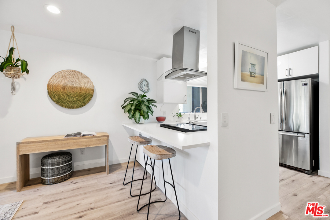 8303 Raintree Circle Culver City, CA 90230 - Photo 8 of 26 a kitchen with stainless steel appliances granite countertop a stove a refrigerator and a wooden floor