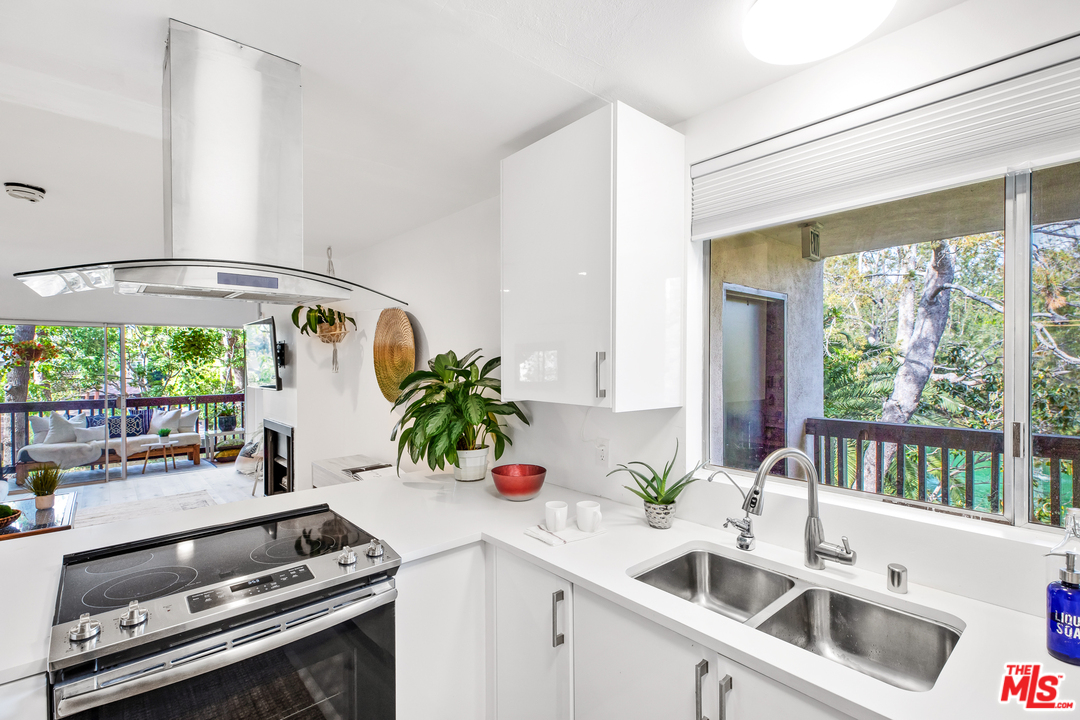 8303 Raintree Circle Culver City, CA 90230 - Photo 10 of 26 a kitchen with a sink stove and cabinets