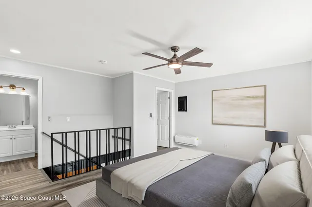 a bedroom with a large bed chandelier and a window