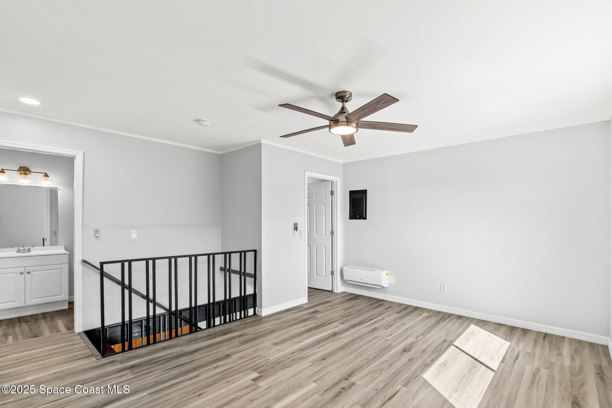 3316 Overlook Drive, Unit 62 Palm Bay, FL 32905 - Photo 15 of 23 an empty room with wooden floor and windows