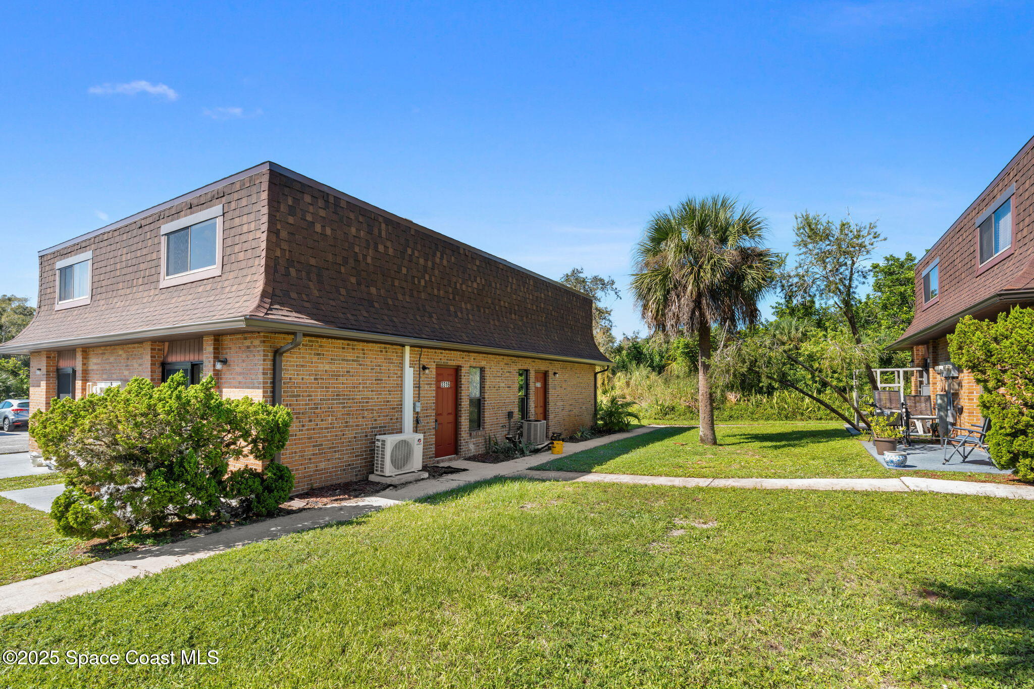3316 Overlook Drive, Unit 62 Palm Bay, FL 32905 - Photo 2 of 23 a backyard of a house with table and chairs