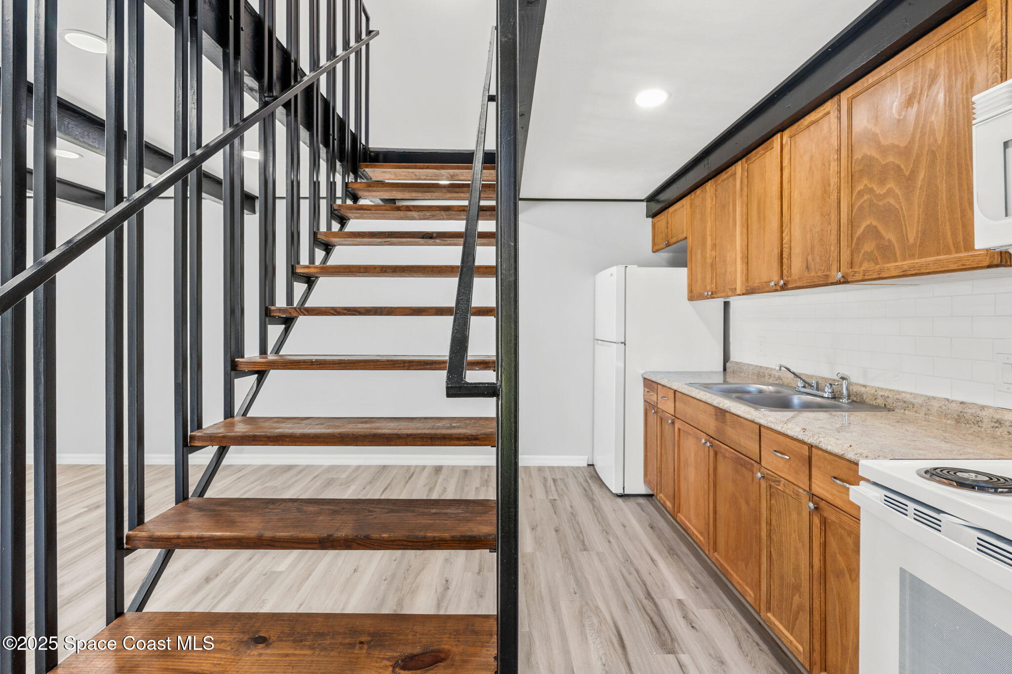 3316 Overlook Drive, Unit 62 Palm Bay, FL 32905 - Photo 4 of 23 a view of a kitchen with wooden floor and electronic appliances