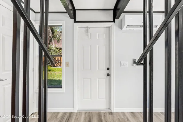 a view of entryway with wooden floor and door
