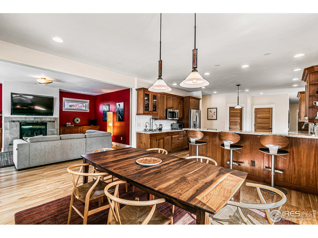 a living room with furniture a dining table and a fireplace