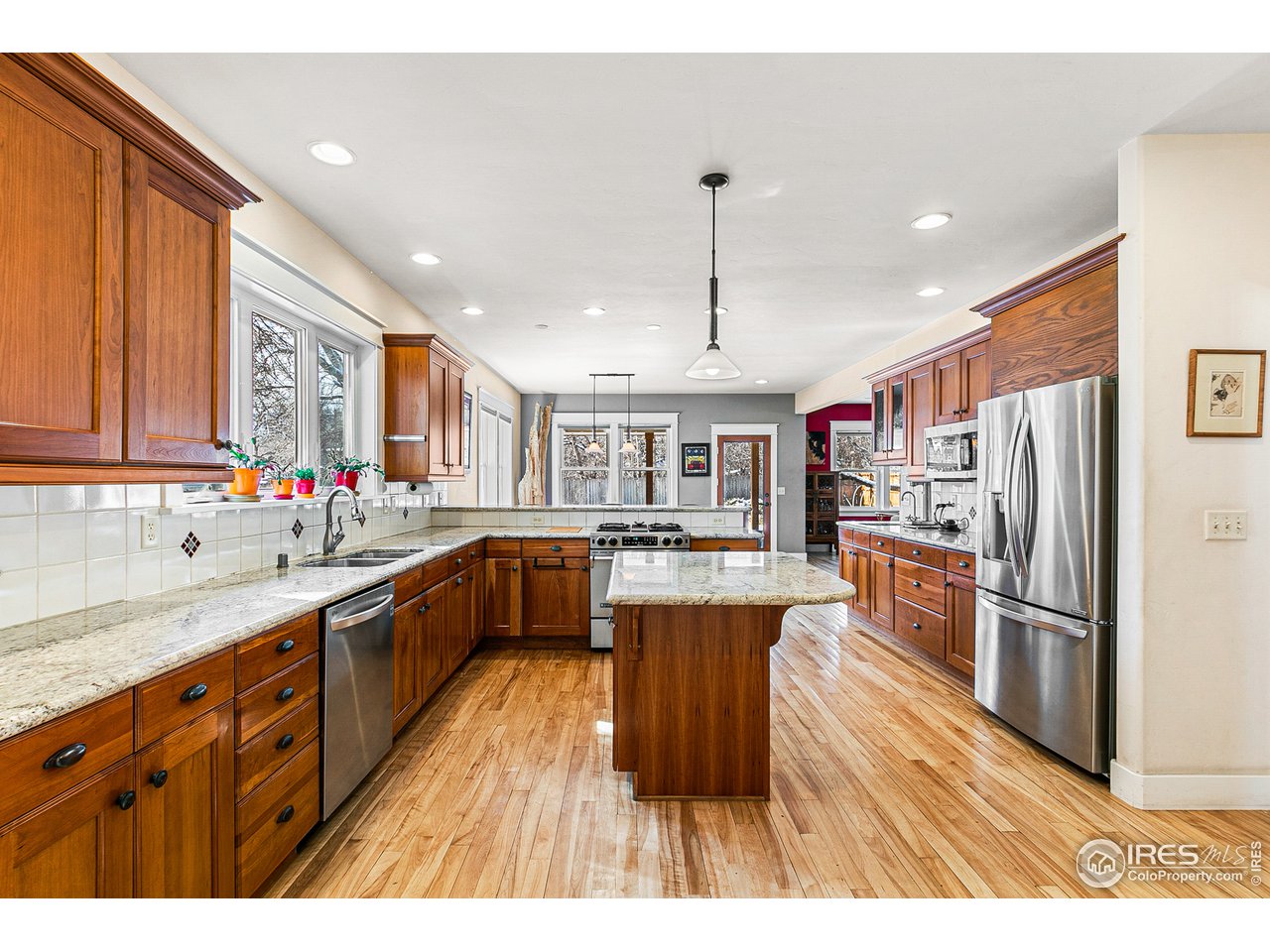 2853 14th Street Boulder, CO 80304 - Photo 12 of 40 a kitchen with stainless steel appliances granite countertop a refrigerator a sink dishwasher a stove with wooden floor