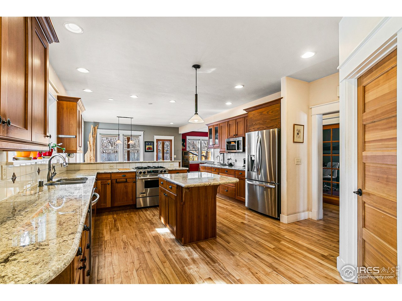 2853 14th Street Boulder, CO 80304 - Photo 13 of 40 a kitchen with stainless steel appliances granite countertop a refrigerator a sink dishwasher and a stove with wooden floor