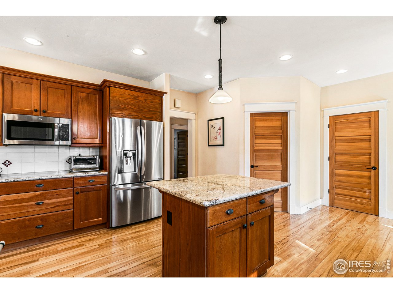 2853 14th Street Boulder, CO 80304 - Photo 14 of 40 a kitchen with stainless steel appliances granite countertop a refrigerator a sink dishwasher a stove and a refrigerator with wooden floor