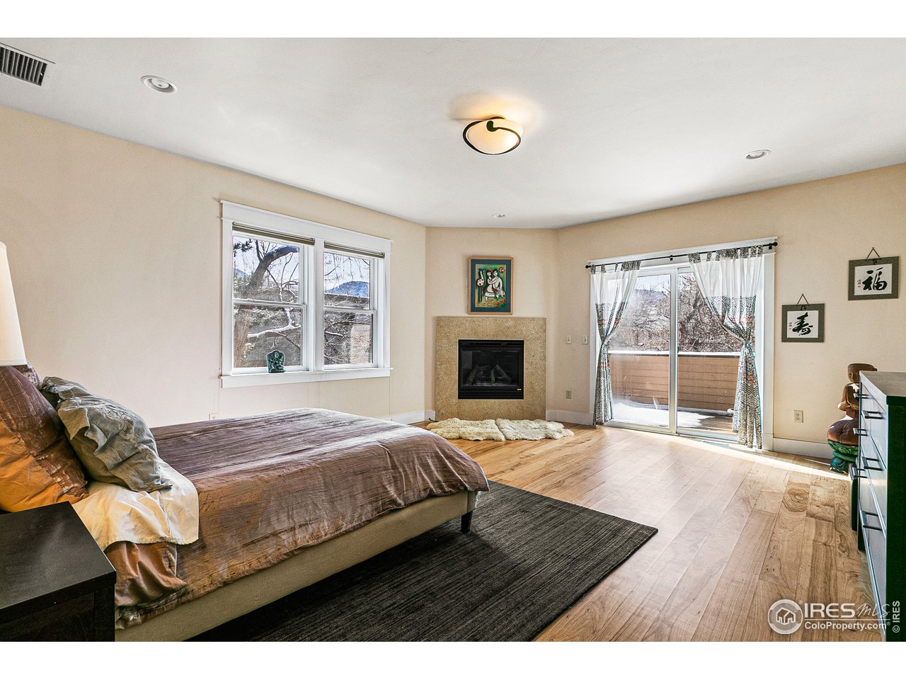 2853 14th Street Boulder, CO 80304 - Photo 25 of 40 a bedroom with a bed and wooden floor