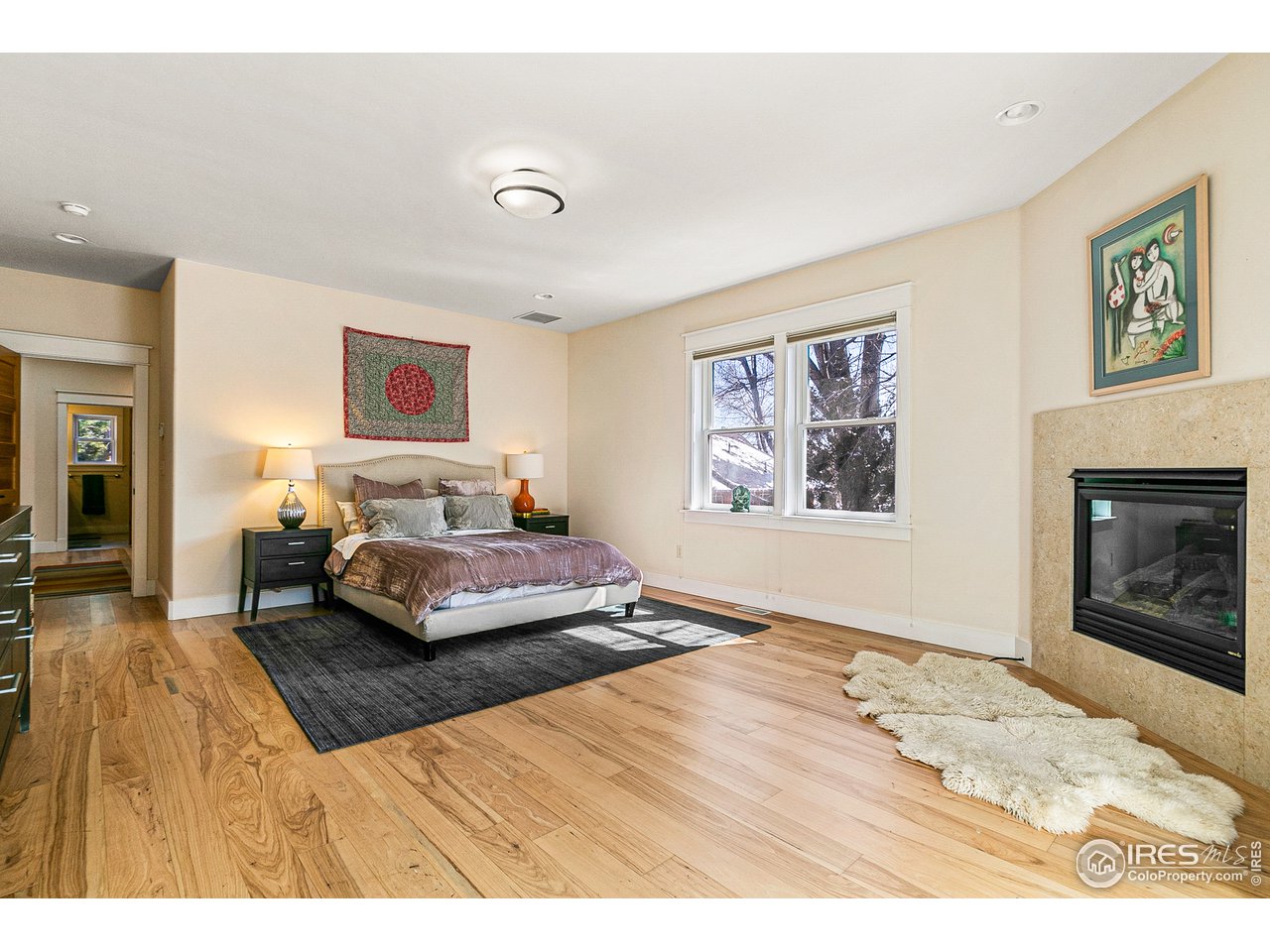 2853 14th Street Boulder, CO 80304 - Photo 26 of 40 a bedroom with a bed and a fireplace