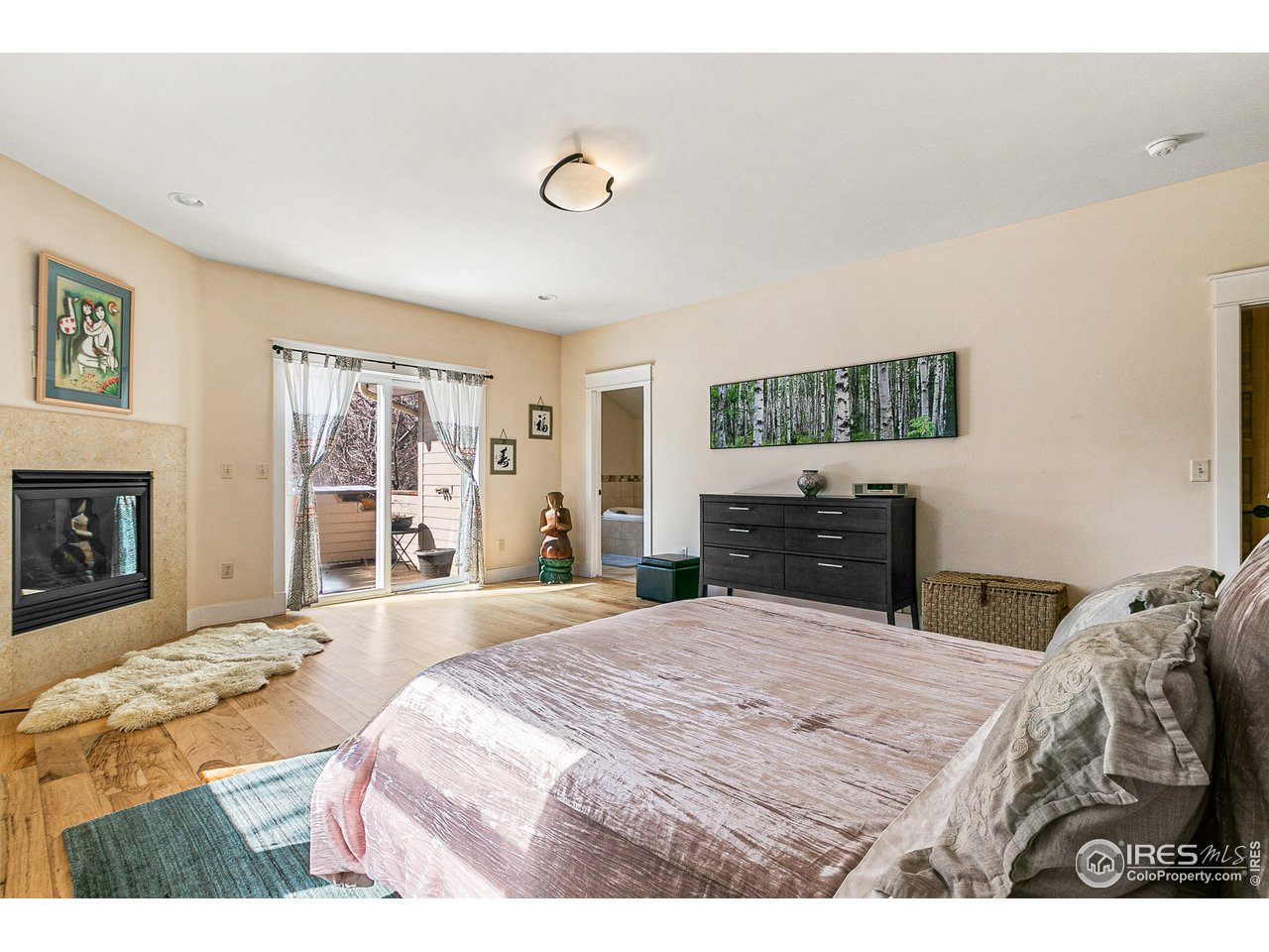 2853 14th Street Boulder, CO 80304 - Photo 27 of 40 a bedroom with a bed and a flat screen tv