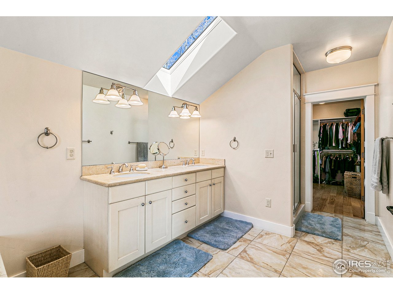 2853 14th Street Boulder, CO 80304 - Photo 28 of 40 a bathroom with a sink a mirror and a shower