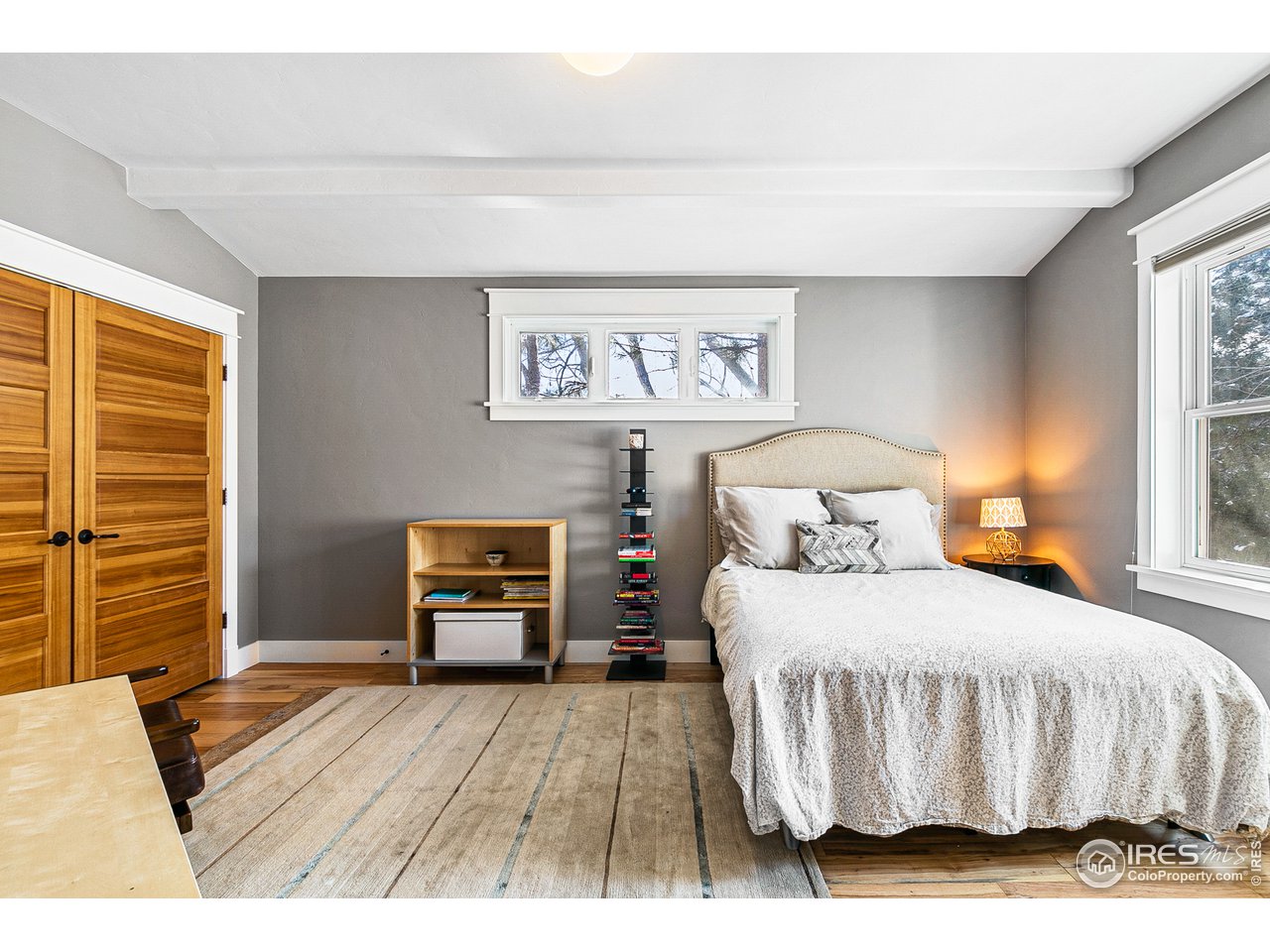 2853 14th Street Boulder, CO 80304 - Photo 32 of 40 a bedroom with a bed and wooden floor