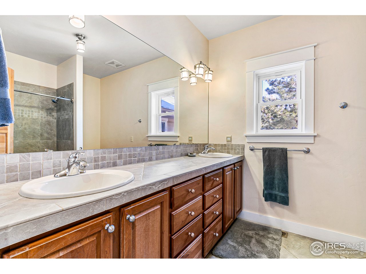 2853 14th Street Boulder, CO 80304 - Photo 34 of 40 a bathroom with a sink double vanity granite and a shower