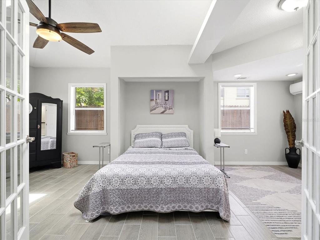 1207 1st Street Indian Rocks Beach, FL 33785 - Photo 22 of 60 a bedroom with a large bed and a chandelier