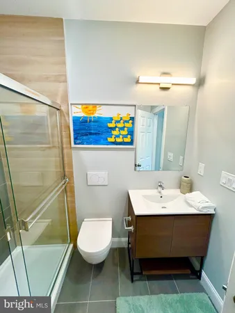 a bathroom with a sink mirror vanity and toilet